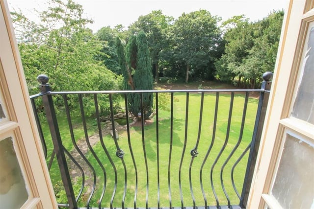 A balcony view of the parkland-style grounds.