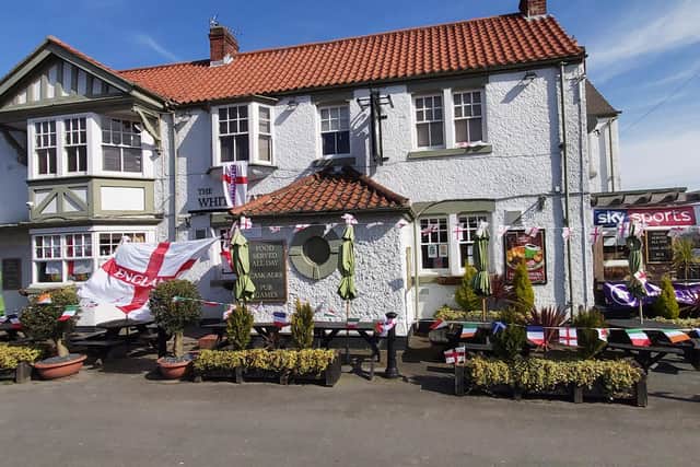 The White Hart Pub in Wadsworth decorated with flags.