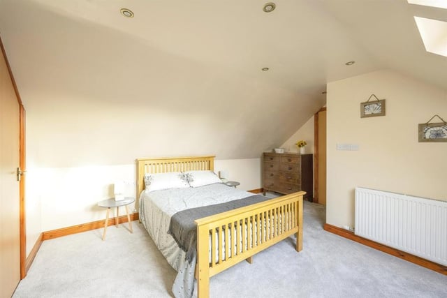 Bedroom Four - A double room with a double glazed roof window and a central heating radiator.