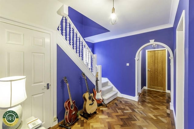 A bright and welcoming hallway with parquet flooring.
