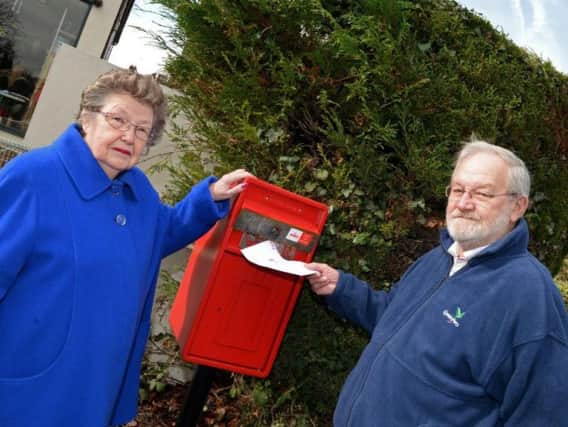 Molly and John Whiteside outside the new post box which can't be used because Royal Mail lost the key
