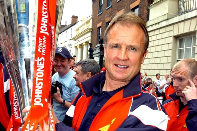 Sean O'Driscoll hoists the trophy aloft at a victory parade outside the Mansion House.