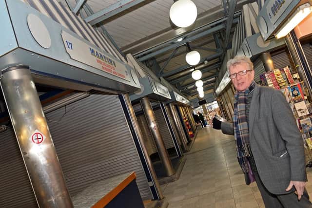 Mick Maye, a market trader for over 40 years, pictured by a row of empty units