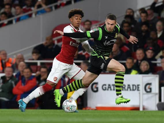 Tommy Rowe looks to get away from Arsenal's Reiss Nelson