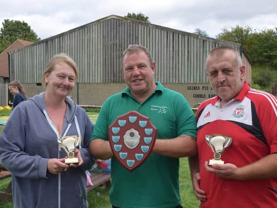 Shepherd's Place Farm owner Ted Phillips (centre) presents prizes to Sarah and Ian after their mammoth eating challenges.