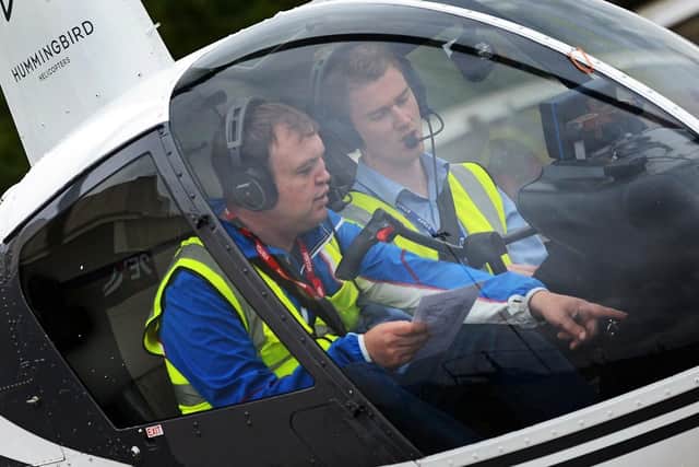 Instructor Alasdair Hutt, pictured with a student in a two seater Robinson R22. Picture: Marie Caley NDFP-04-09-18-Hummingbird-1