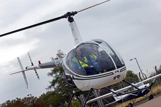 Instructor Alasdair Hutt, pictured with a student in a two seater Robinson R22. Picture: Marie Caley NDFP-04-09-18-Hummingbird-4