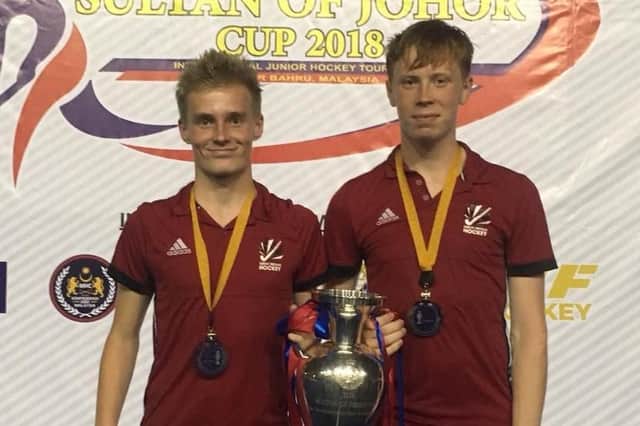 Dan West, left, and Adam Buckle are pictured with the Sultan of Johor Cup.