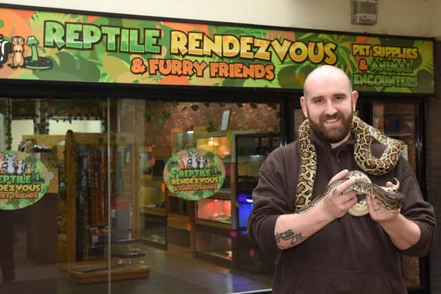 Lucan Handley, of Reptile Rendezvous with two pythons at their shop in Waterdale, Doncaster.
