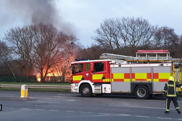 The raging fire at the side of the road. Picture: Tony Critchley