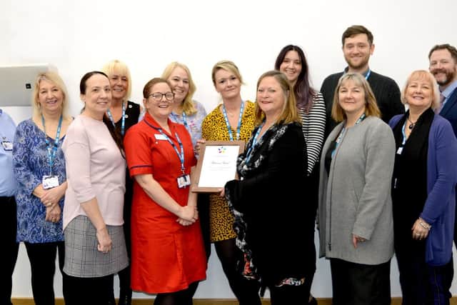 Hospital staff with the award