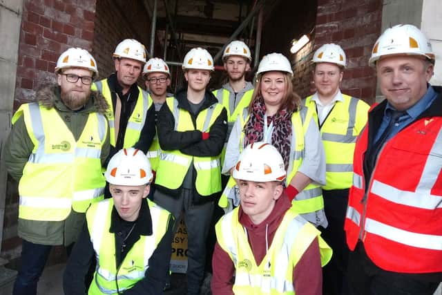 Pupils from Communication Specialist College with Willmott Dixon construction manager Mark Cox on the site of the Doncaster museum and library at Waterdale