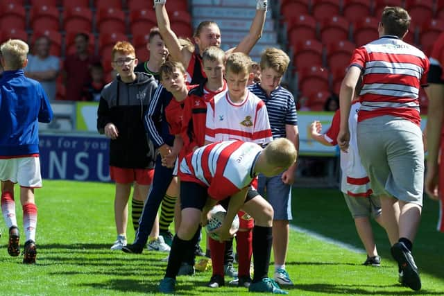 Young supporters play games with Rovers players at an open training session