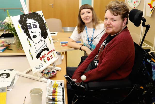 Phillip Hood is pictured with his painting and hospice art therapist Rachel Horne