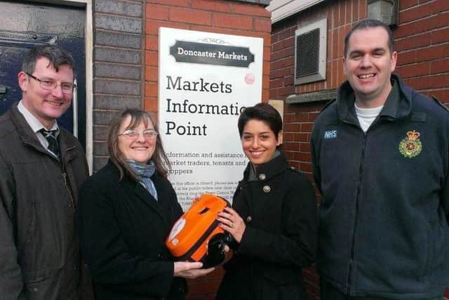 Handing over the defibrillator, back in 2013,  was Pat Gardner (second left) with Doncaster Markets facilities manager John Clarke, business relations manager Amy Lindsay and Yorkshire Ambulance Service's community defibrillator trainer Warren Bostock.