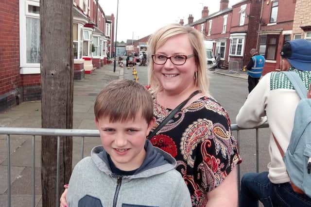 Film crews shooting Still Open All Hours at Lister Avenue, Doncaster, on June 3, 2019. Pictured are Sam Evans, aged eight, with mum Emily Evans, aged 40, from Bolsover, Derbyshire
