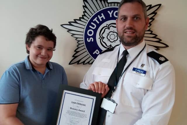 Sam Firbank, aged 14, with Supt Dan Thorpe at Doncaster Police Station. receiving a commendation for his bravery.
