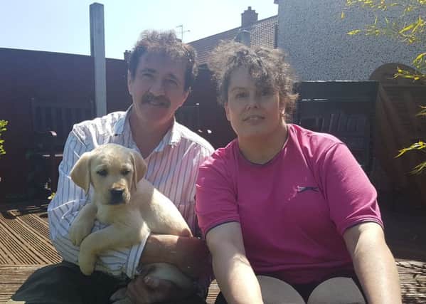 Marky, pictured with foster couple Gary and Joanne Smillie from Woodlands, is the first pooch to be recruited by charity Support Dogs as part of their new puppy programme
