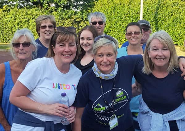 Fundraiser Sharon Tune (centre) is pictured with Glow Walkers on one of the training walks.