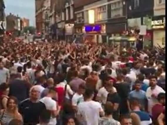 Fans celebrate an England win in Silver Street, Doncaster