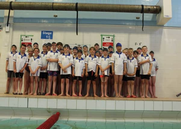 Some of the current squad at a recent gala, wearing their 50thanniversary swimming caps and t-shirts