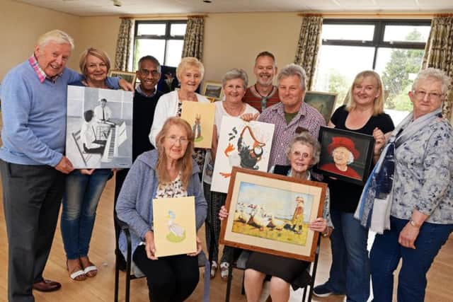 Mark Holiday, group tutor, pictured with members of Hayfield Art group, during their annual exhibition at Bawtry New Hall. Picture: Marie Caley NDFP Hayfield Art Group MC 1
