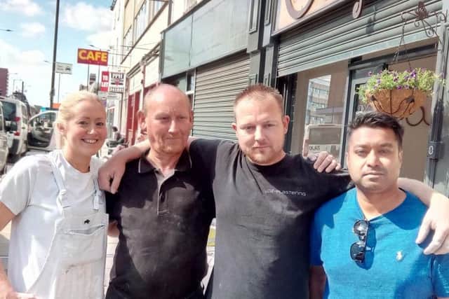 David Singh, right, with builders outside Singh's Arcade, on St Sepulchre Gate, Doncaster town centre. PIcture: David Kessen