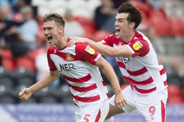 Joe Wright celebrates his goal with John Marquis