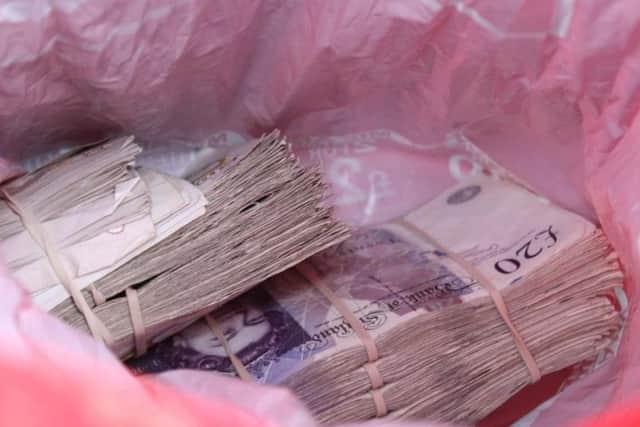 HMRC officers seized this cash from the tobacco gang, that was being stored in a carrier bag