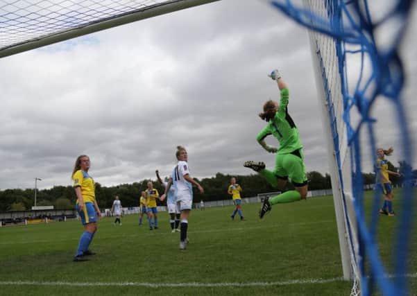 Acrobatics from Belles goalkeeper Emily Batty. Photo: Julian Barker