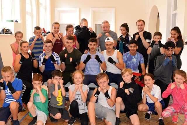 Coaches Paul Harrison, Rob Harper and Sam Foster, pictured with members of the Doncaster Plant Works Amateur Boxing Club. Picture: Marie Caley
