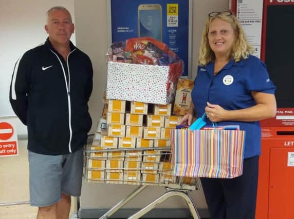 Steve Cole, of Doncaster Children's Services Trust, receives a food donation from Amanda Woods, of Tesco.