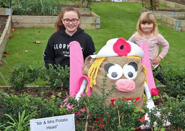 Keira Parkin and Matilda Ford are pictured with a Mrs Potato Head scarecrow they made for the 2017 Flourish Enterprises scarecrow fesitval.