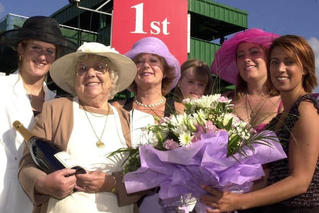 Doncaster news: 12/9/2002

Great grandma and Doncaster Star reader Ann Davison (second left) was presented  with free tickets, a bottle of champagne and flowers......and got a mention in the race day card on the St Leger Festival Ladies Day.  Our picture shows her with daughter Anne Neale (third left), granddaughters Rachel Neale (left), aged 21, and Claire Neale (fifth left), aged 24, great granddaughter Ricci Neale, aged three, and  Lucy Allen (right), PR with The Rothman's Royals St Leger Festival Press Office.