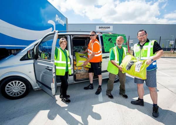 Liz and Kelvin Wigan from Mayflower Sanctuary helping load their van with a donation from Amazon LBA2 Doncaster. Helping are Amazon Associates Pete Bacon(orange top)and Mitchell Kempster.