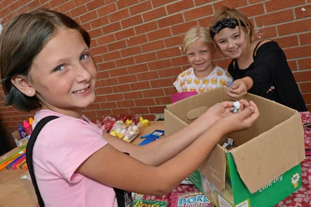 Pictured having a go on the Tombola are l-r Ebony Robinson, Star McAdam and Freya Gilliland, all eight. Picture: Marie Caley NDFP-18-08-18-MylaFundraiser-6