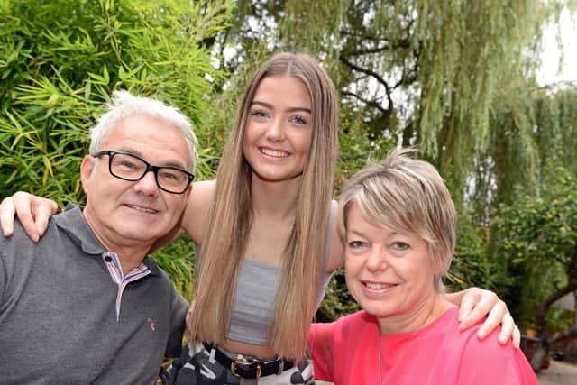 Charlotte Lee, pictured with her parents Mike and Liz. Picture: Marie Caley
