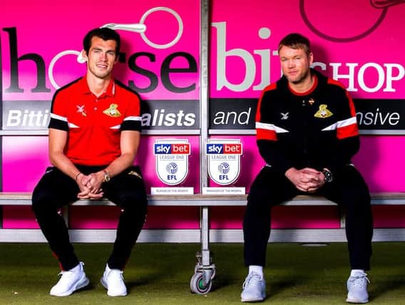 John Marquis and Grant McCann with the League One player and manager of the month prizes