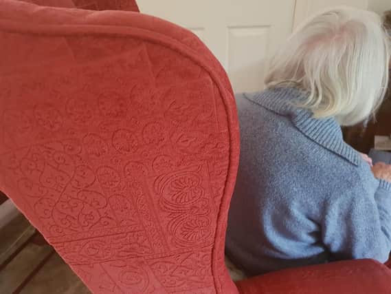 Elderly person sitting alone