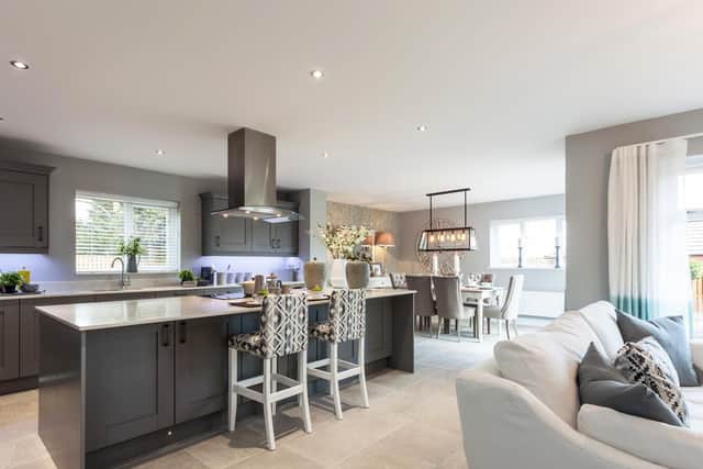 Typical Duchy Homes open plan kitchen/dining/living space with bi-fold doors to rear garden