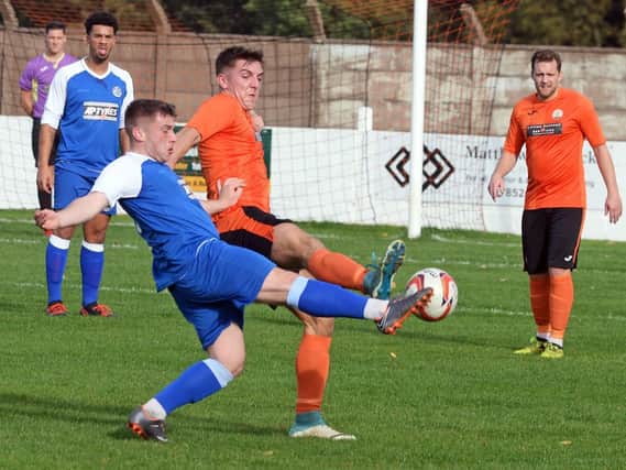 Harworth's Matthew Robinson challenges for the ball against Parkgate.