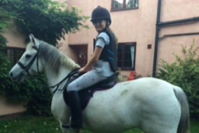 Alyssia Marsh on her pony at her new home.