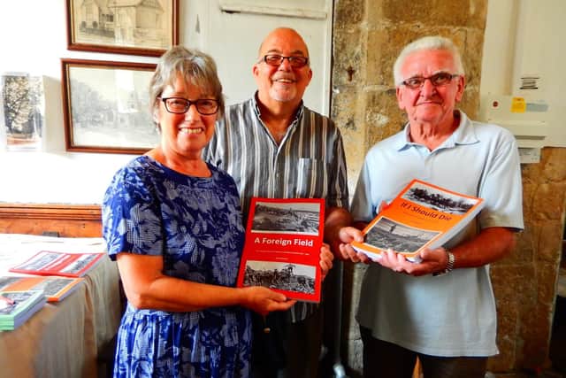 David Seymour (centre) is pictured with some of the first residents to buy signed copies of books two and three, Sandra and Michael Butler.