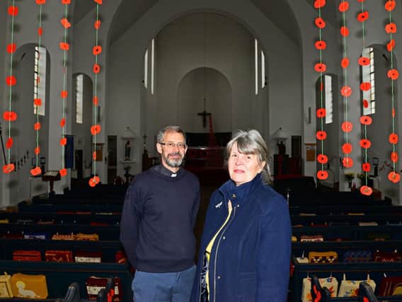 Rev. Ian Smith and Jill Sharp, church warden, pictured at St.Peter's Church, in Warmsworth, where hundreds of Poppies have been installed, creating a huge Poppy display around the church