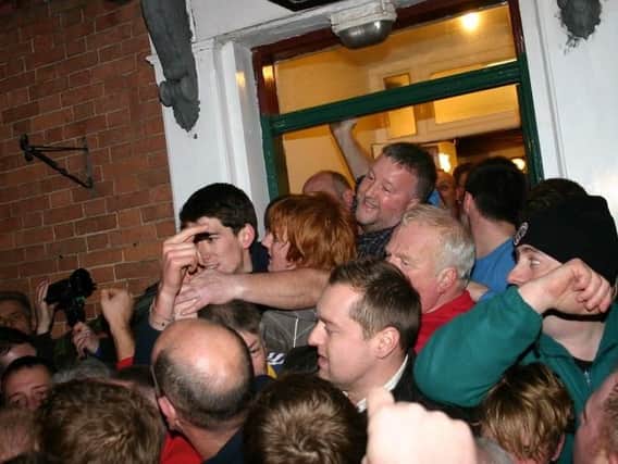 Duke William landlord Paul Chapman reaching out for the Haxey Hood in 2012