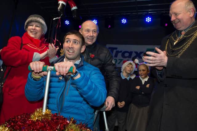 Ben Parkinson switches on the lights with the help of Mayor Cllr Councillor David Nevett and wife Kathleen