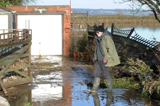 A man surveys flood damage to his property in South Ferriby in 2013