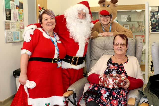 Hospice Sister Joanne Brooks is pictured with Father Christmas, Rudolf and hospice visitor Jane Birchall, who attended the event with her sister Ann