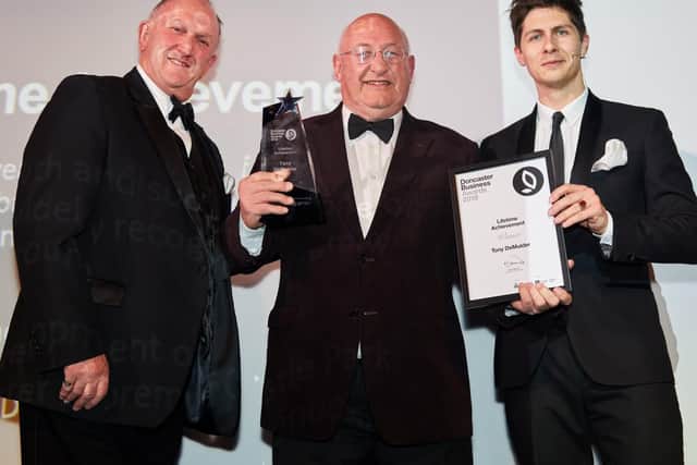 Steve Lloyd presented the lifetime achievement award to Tony de Mulder. They are pictured with the event's host, the comedy magician Ben Hanlin. PIcture: Shaun Flannery