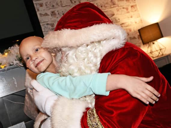Myla Carte, five, gives Santa a hug, after surprising her with a visit to her home. Picture: NDFP-18-12-18-CarteSanta-3
